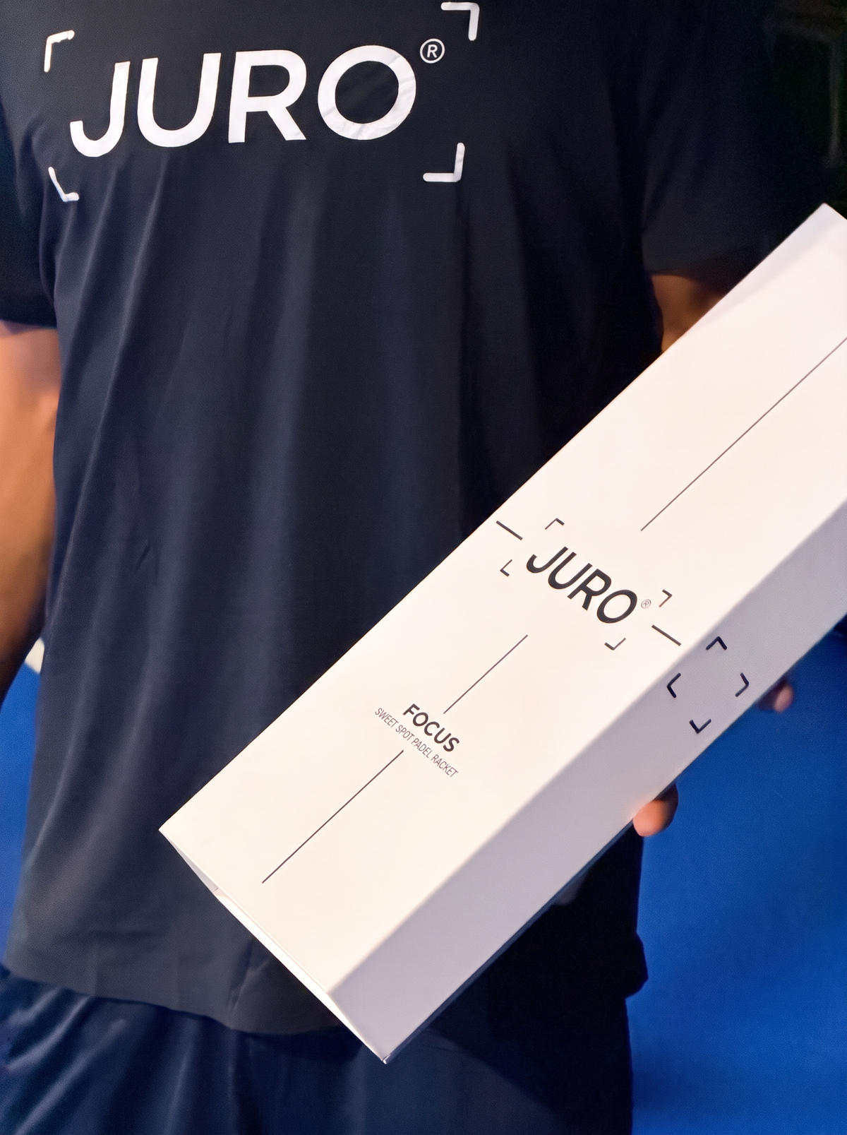A player in a JURO t-shirt holding the JURO FOCUS box